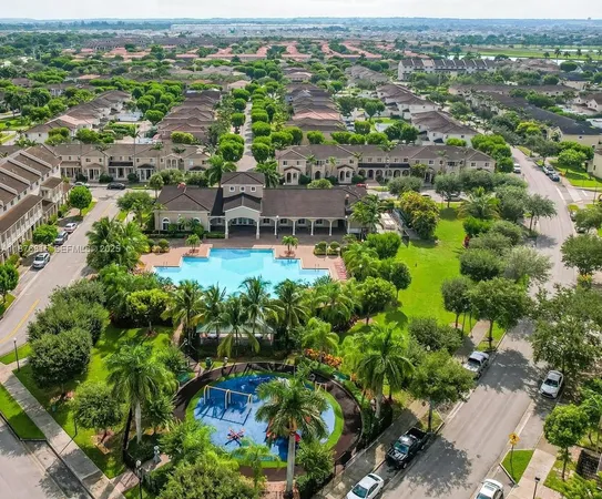 an aerial view of residential houses with outdoor space and swimming pool