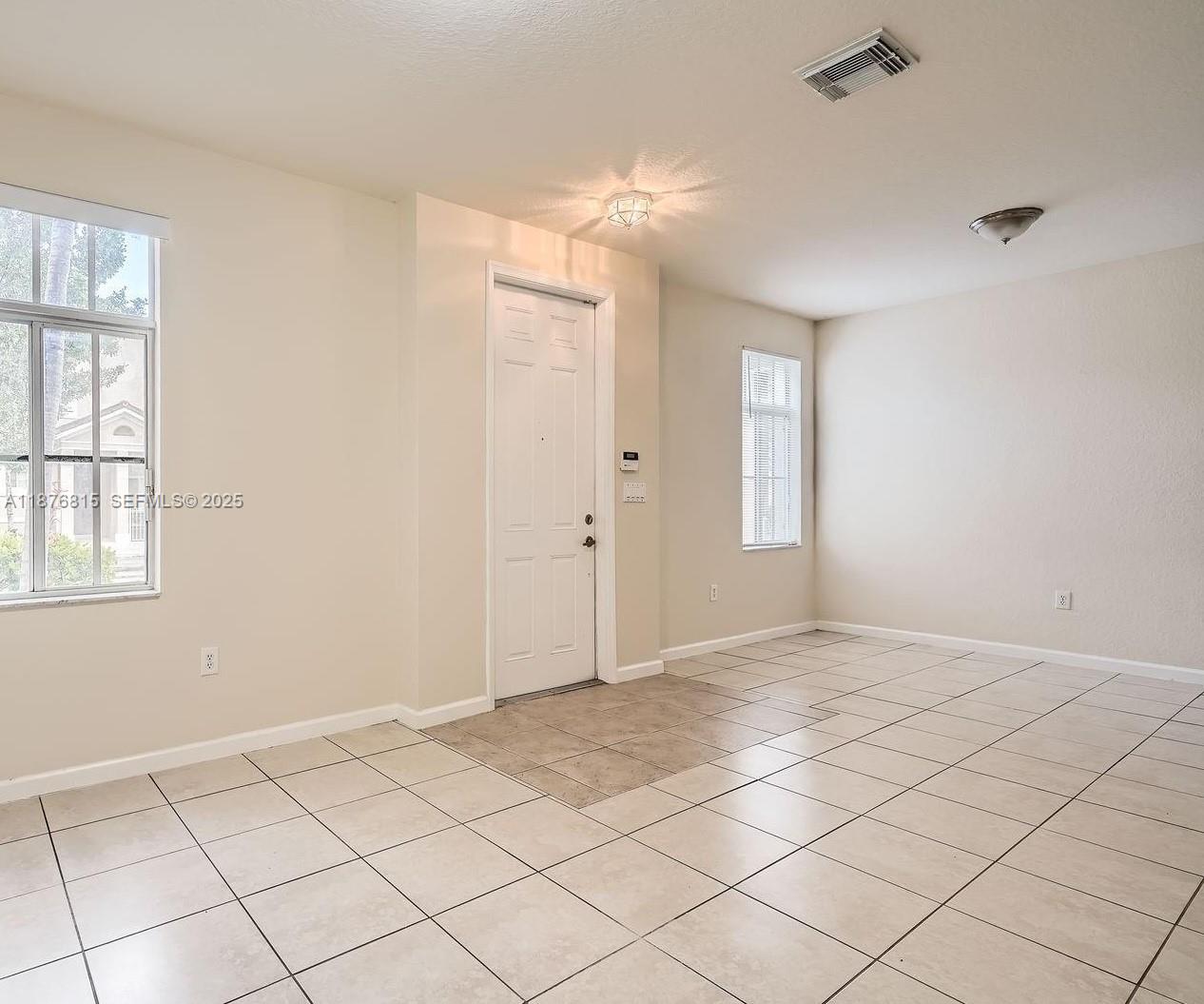 13945 Southwest 279th Lane, Unit 13945 Homestead, FL 33032 - Photo 5 of 14 a view of an empty room and window