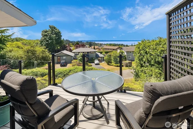 a balcony with table and chairs