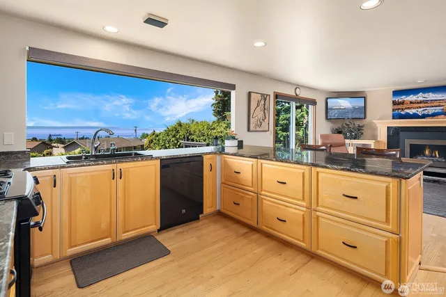 a kitchen with granite countertop white cabinets and white appliances