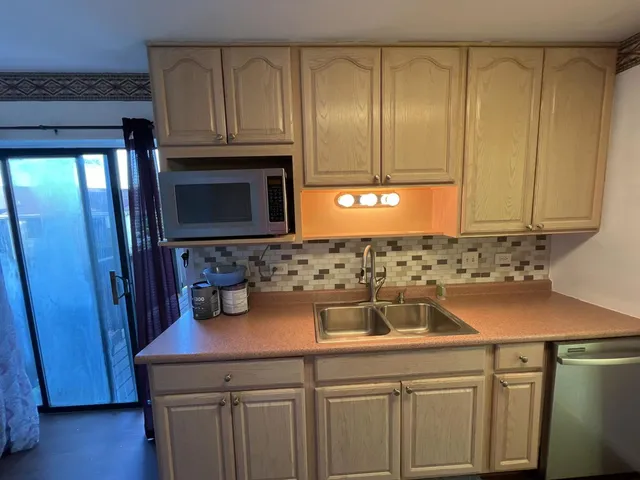 a kitchen with a sink and cabinets