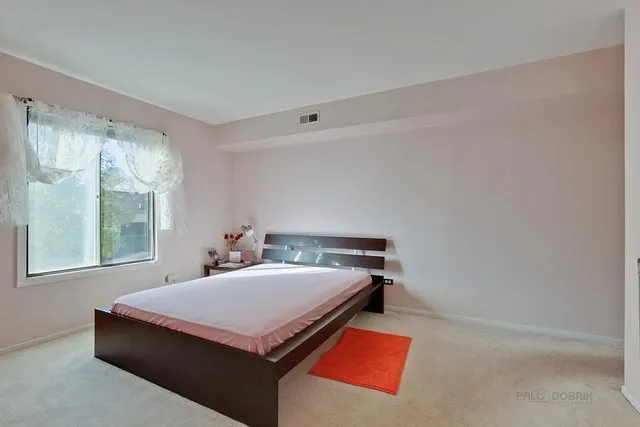 a bedroom with a bed and window