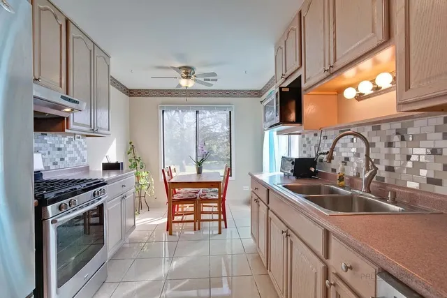 a kitchen with stainless steel appliances a sink stove and cabinets
