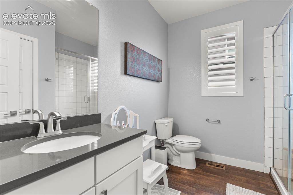 12781 Granite Ridge Drive Peyton, CO 80831 - Photo 21 of 41 Main level bathroom with subway tile and quartz for the upper level bedrooms.