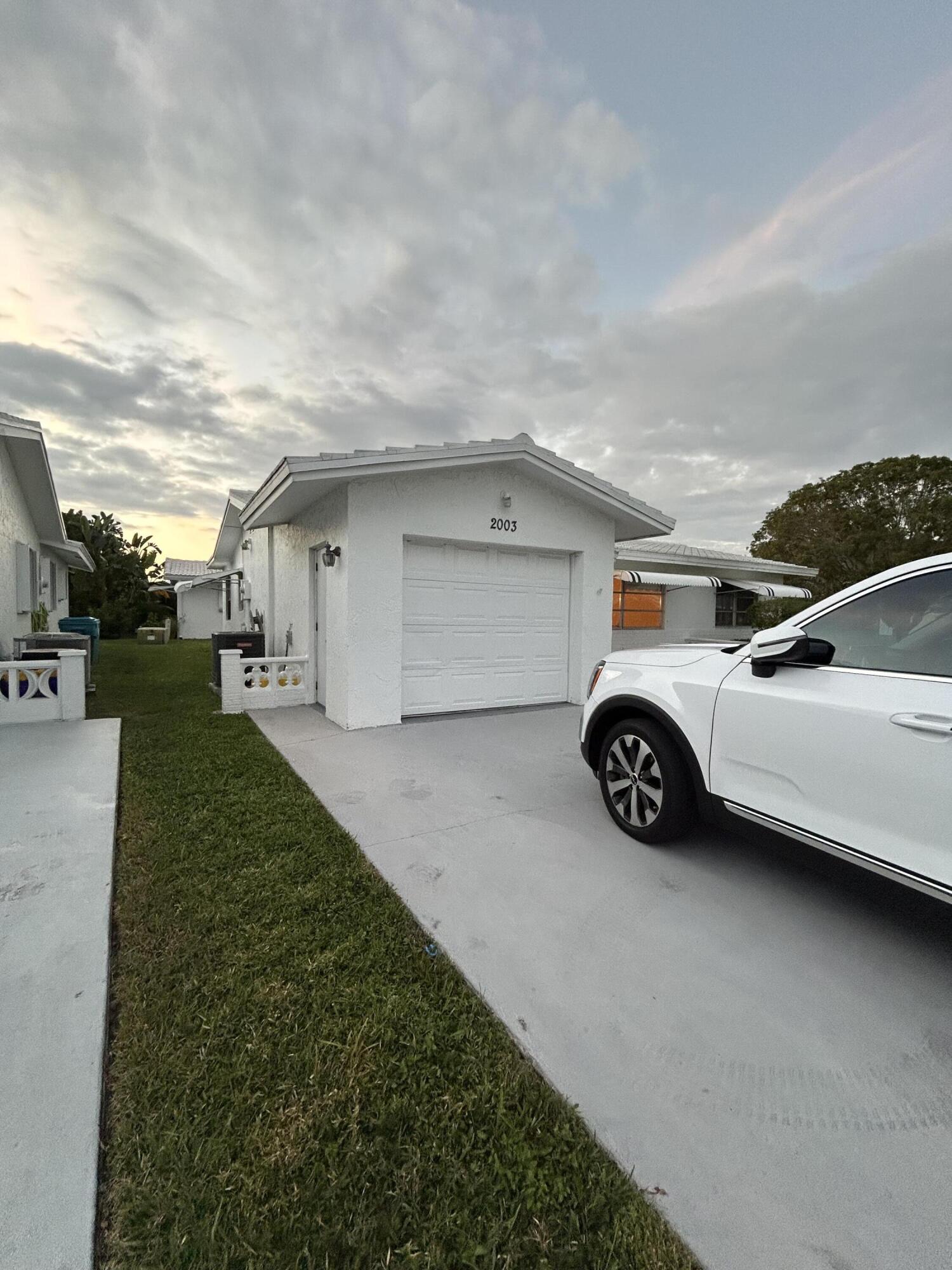 2003 Southwest 18th Street Boynton Beach, FL 33426 - Photo 11 of 11 a view of a car parked in back of a house
