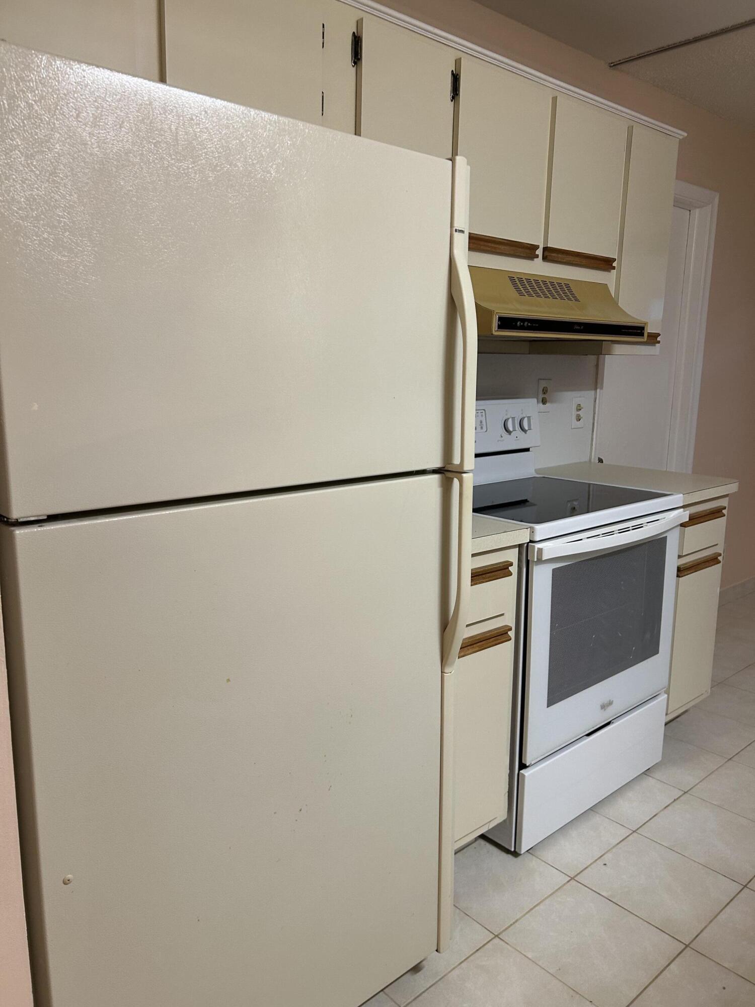 2003 Southwest 18th Street Boynton Beach, FL 33426 - Photo 4 of 11 a white refrigerator freezer and a stove sitting inside of a kitchen