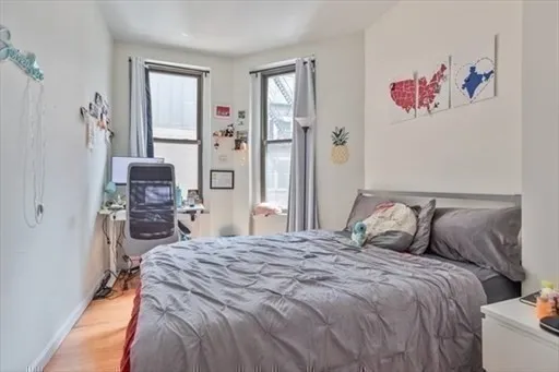 a bedroom with a bed and a chair