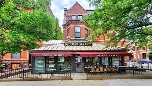 a front view of a building with a garden