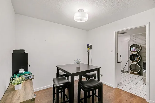 a kitchen with stainless steel appliances granite countertop a sink a stove a washer and dryer