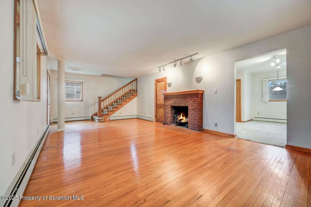 216 North Abington Road Clarks Green, PA 18411 - Photo 13 of 71 a view of an empty room with wooden floor fireplace and a window