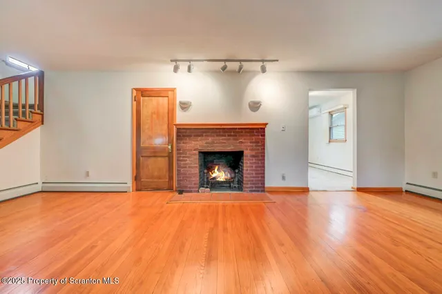 an empty room with windows and chandelier