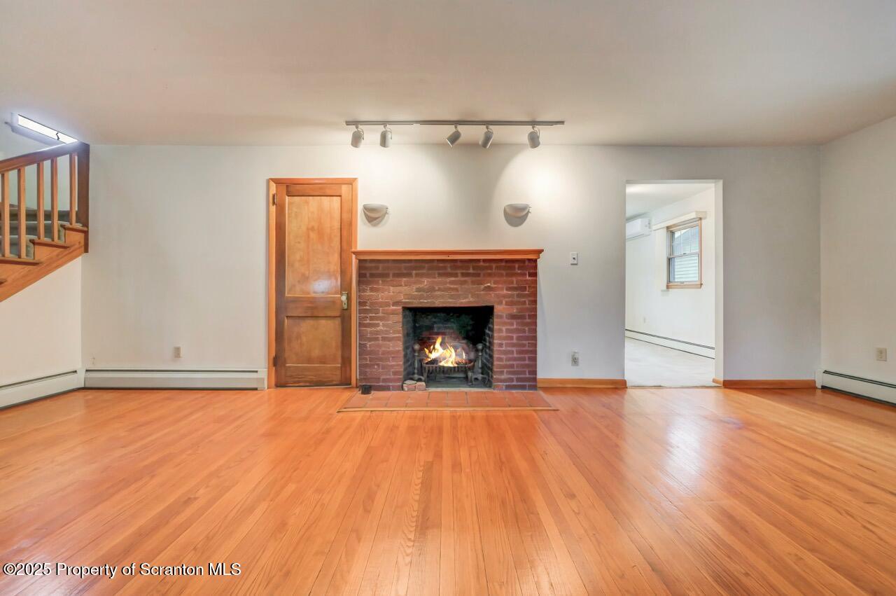 216 North Abington Road Clarks Green, PA 18411 - Photo 14 of 71 a view of empty room with wooden floor and fireplace