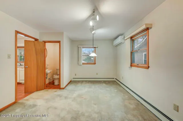 a large white kitchen with a sink and cabinets