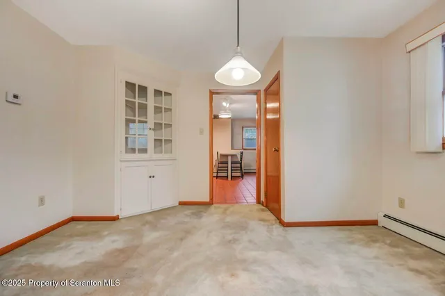 a view of a livingroom with wooden floor and fireplace