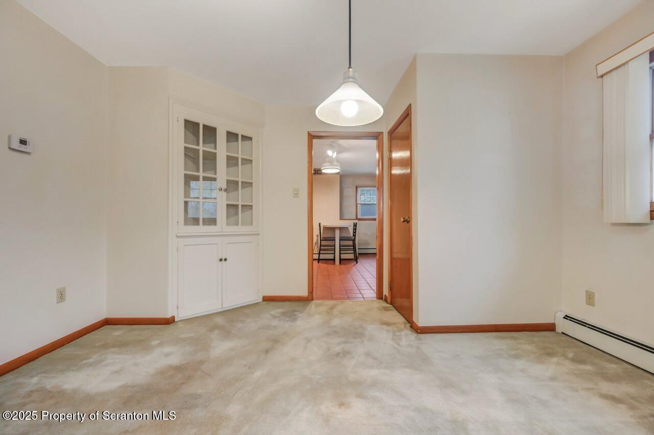 216 North Abington Road Clarks Green, PA 18411 - Photo 20 of 71 an empty room with windows and chandelier