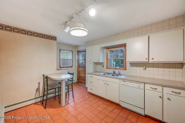 an empty room with closet and windows