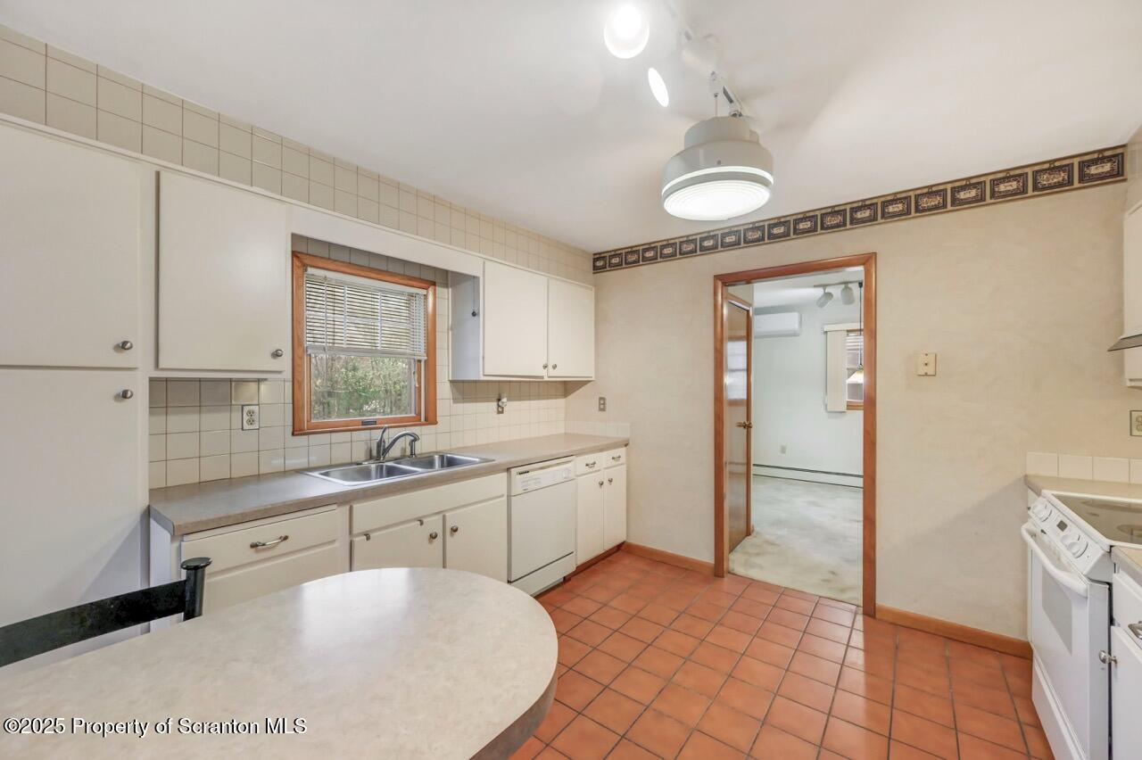 216 North Abington Road Clarks Green, PA 18411 - Photo 25 of 71 a large white kitchen with a sink a window and stainless steel appliances