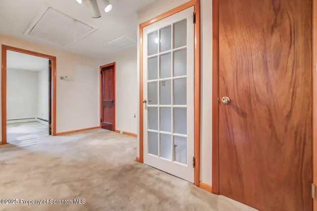 a view of empty room with wooden ceiling
