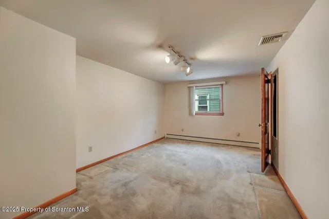 a view of a street with stairs and wooden fence