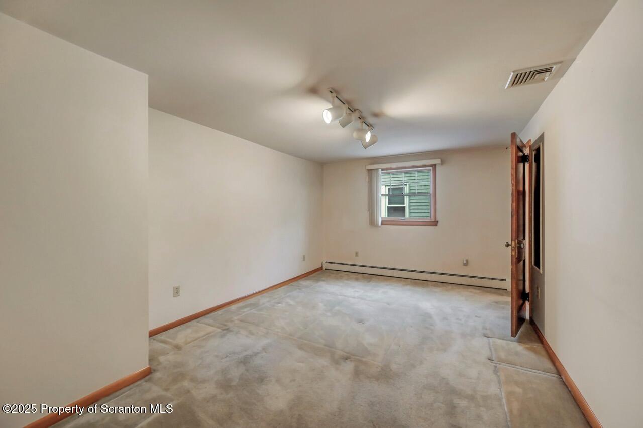 216 North Abington Road Clarks Green, PA 18411 - Photo 42 of 71 an empty room with a ceiling fan and windows