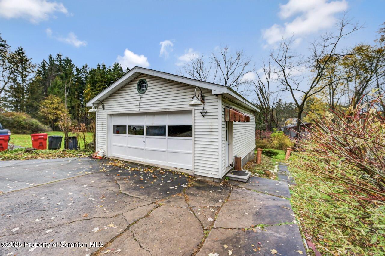 216 North Abington Road Clarks Green, PA 18411 - Photo 6 of 71 a front view of a house with a yard and garage