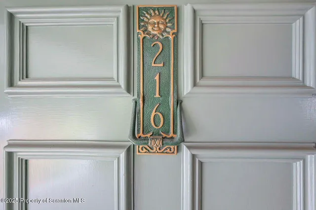 a view of empty room with wooden floor and fireplace