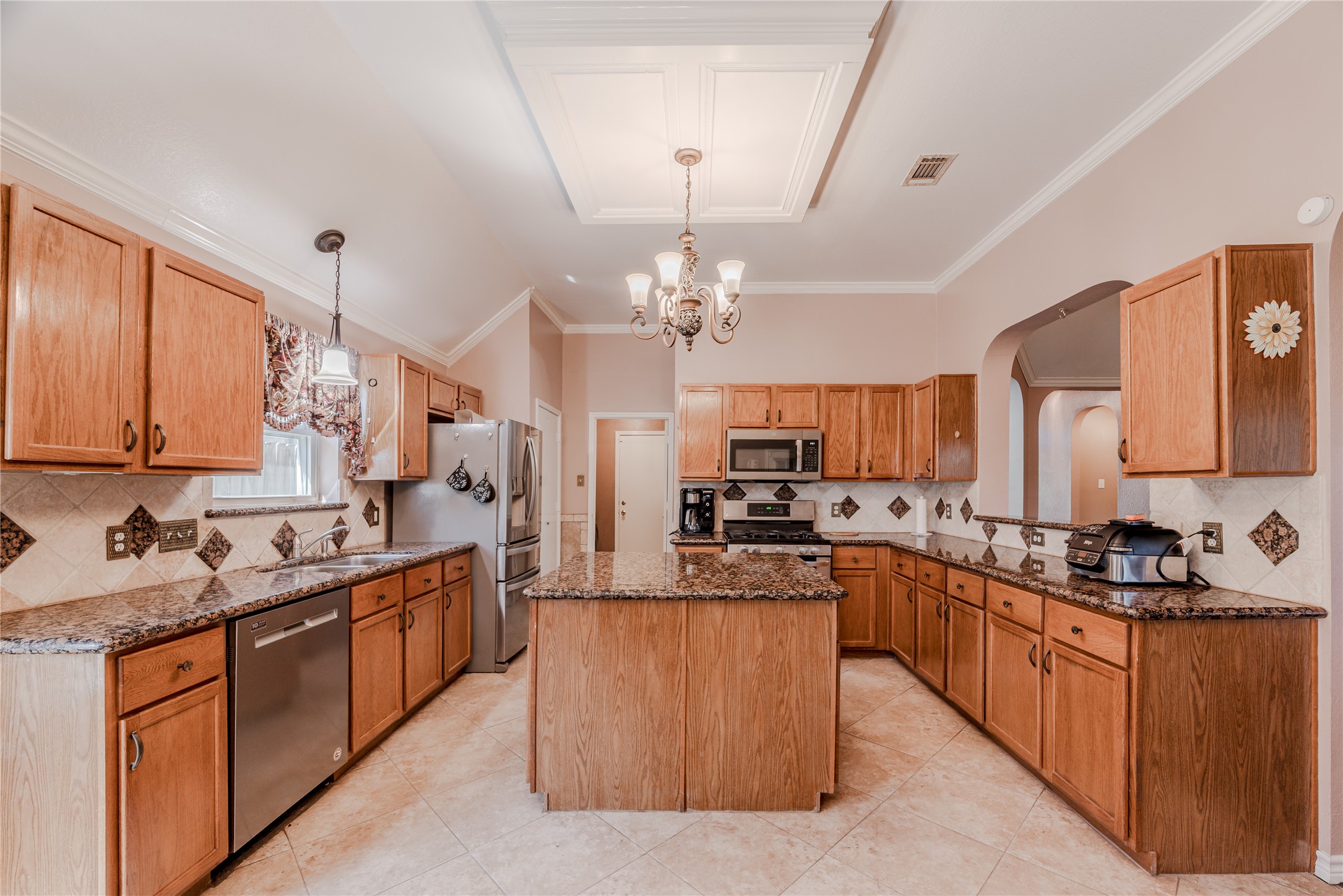 7714 Broken Arrow Street Baytown, TX 77521 - Photo 11 of 41 a kitchen with stainless steel appliances a sink stove and cabinets