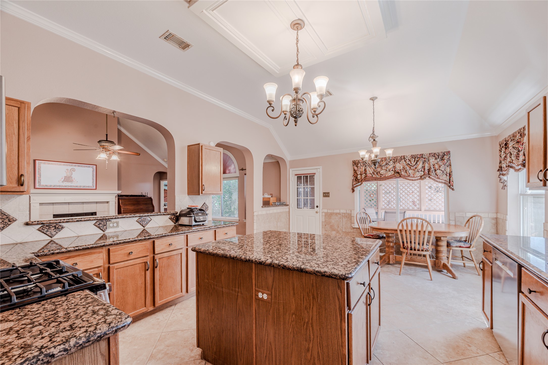 7714 Broken Arrow Street Baytown, TX 77521 - Photo 13 of 41 a kitchen with stainless steel appliances granite countertop a stove a sink dishwasher and white cabinets with wooden floor