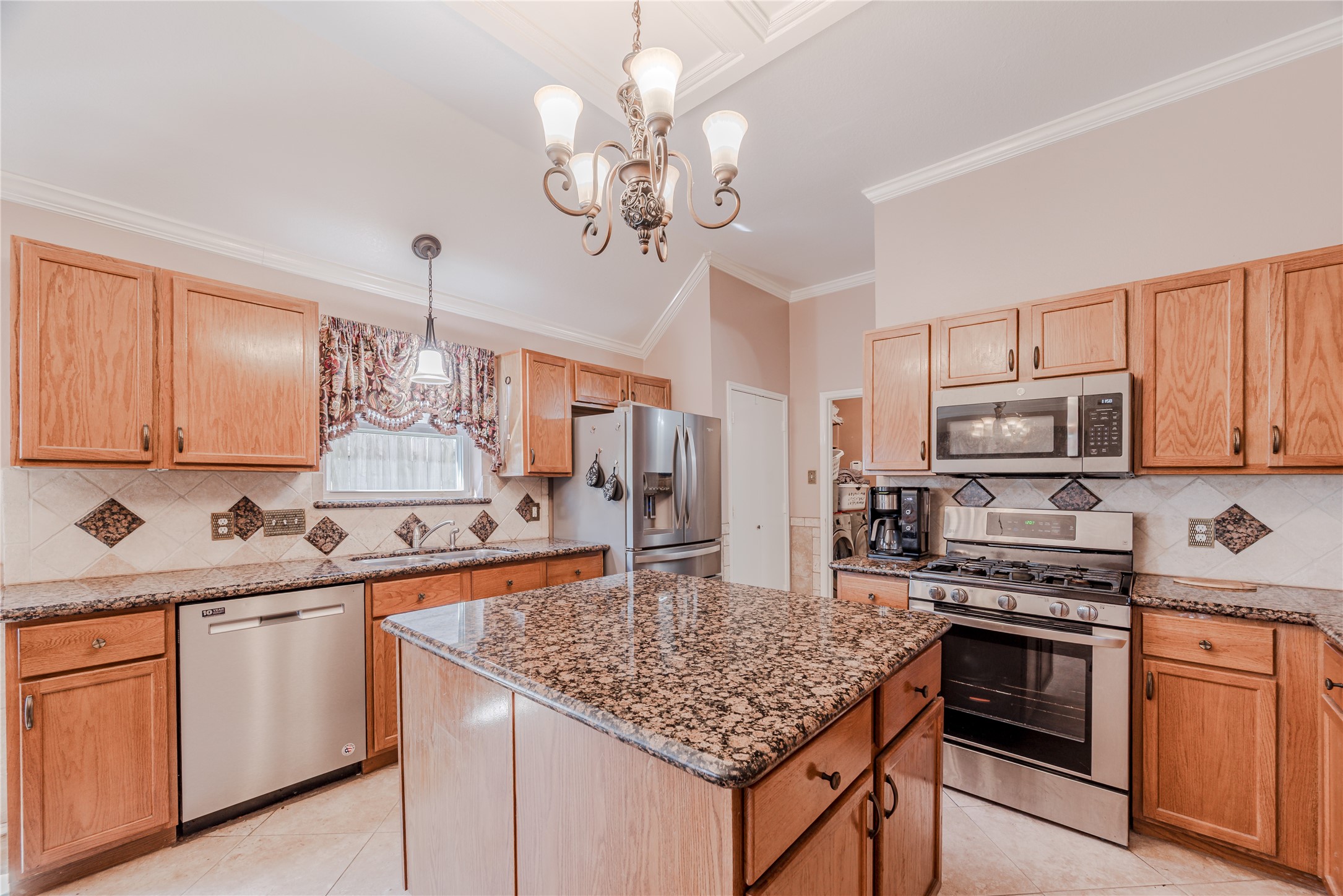 7714 Broken Arrow Street Baytown, TX 77521 - Photo 14 of 41 a kitchen with stainless steel appliances granite countertop a sink dishwasher stove and refrigerator