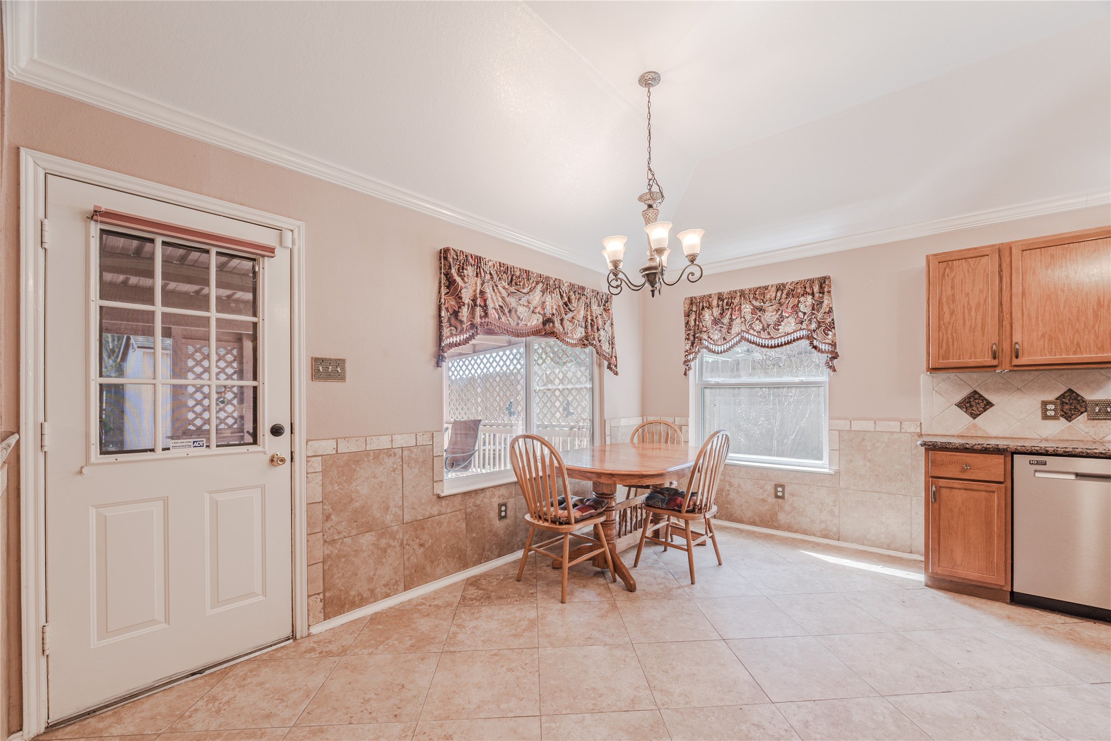 7714 Broken Arrow Street Baytown, TX 77521 - Photo 15 of 41 a view of a dining room with furniture large windows and wooden floor