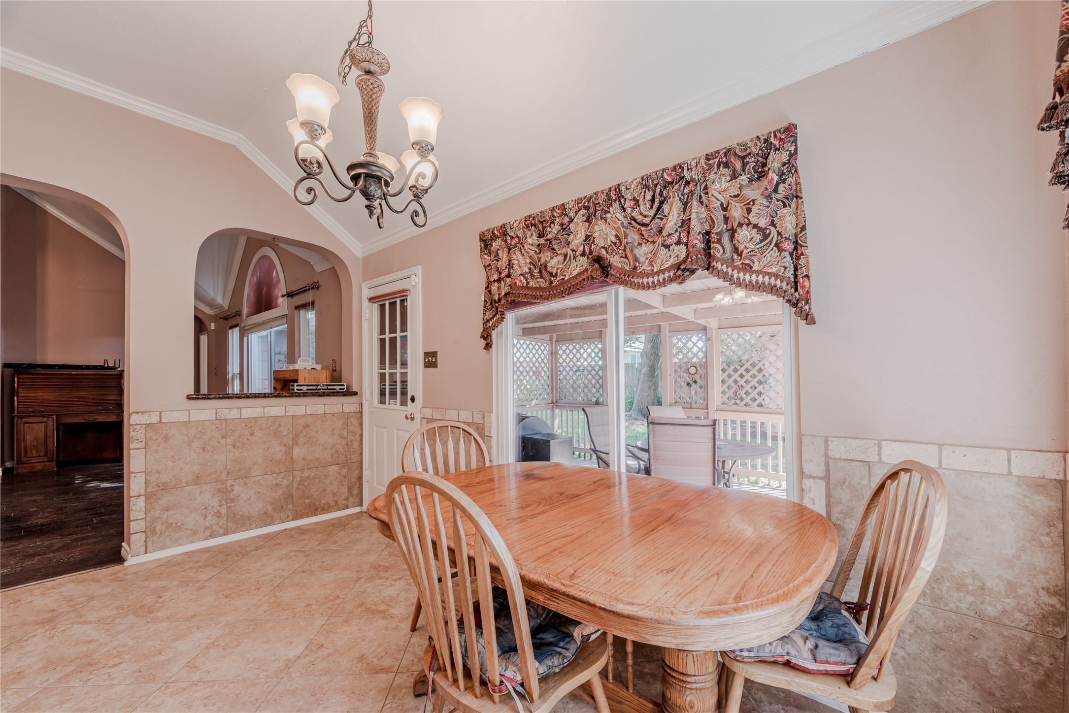 7714 Broken Arrow Street Baytown, TX 77521 - Photo 17 of 41 a view of a dining room with furniture a chandelier and wooden floor