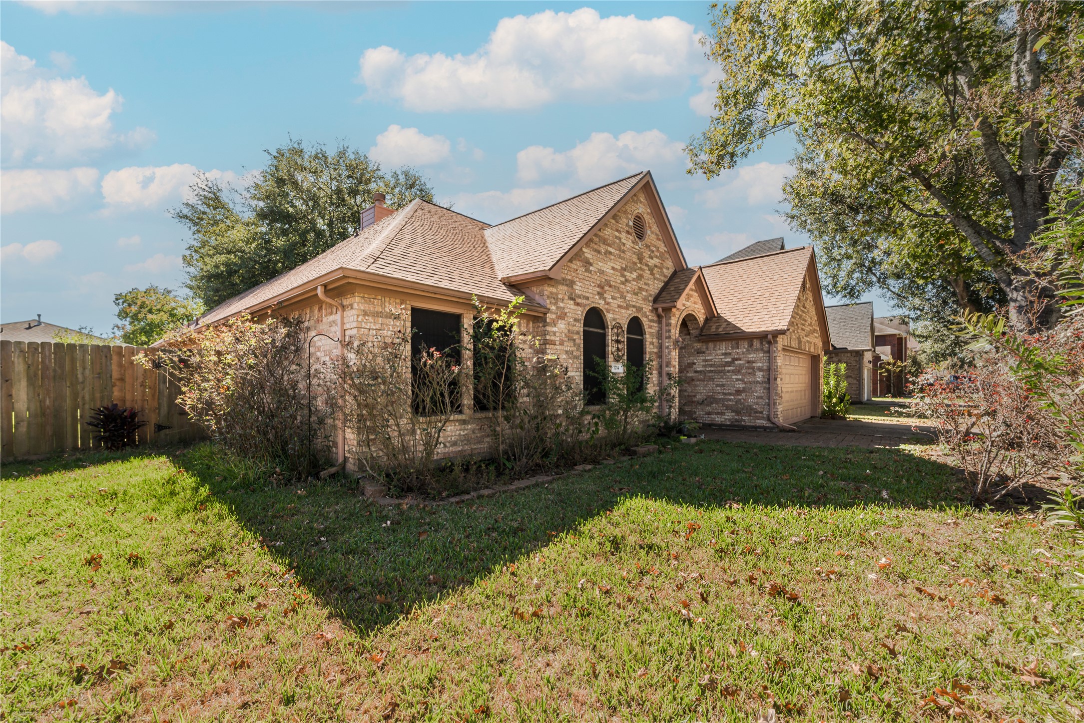 7714 Broken Arrow Street Baytown, TX 77521 - Photo 2 of 41 a front view of a house with garden
