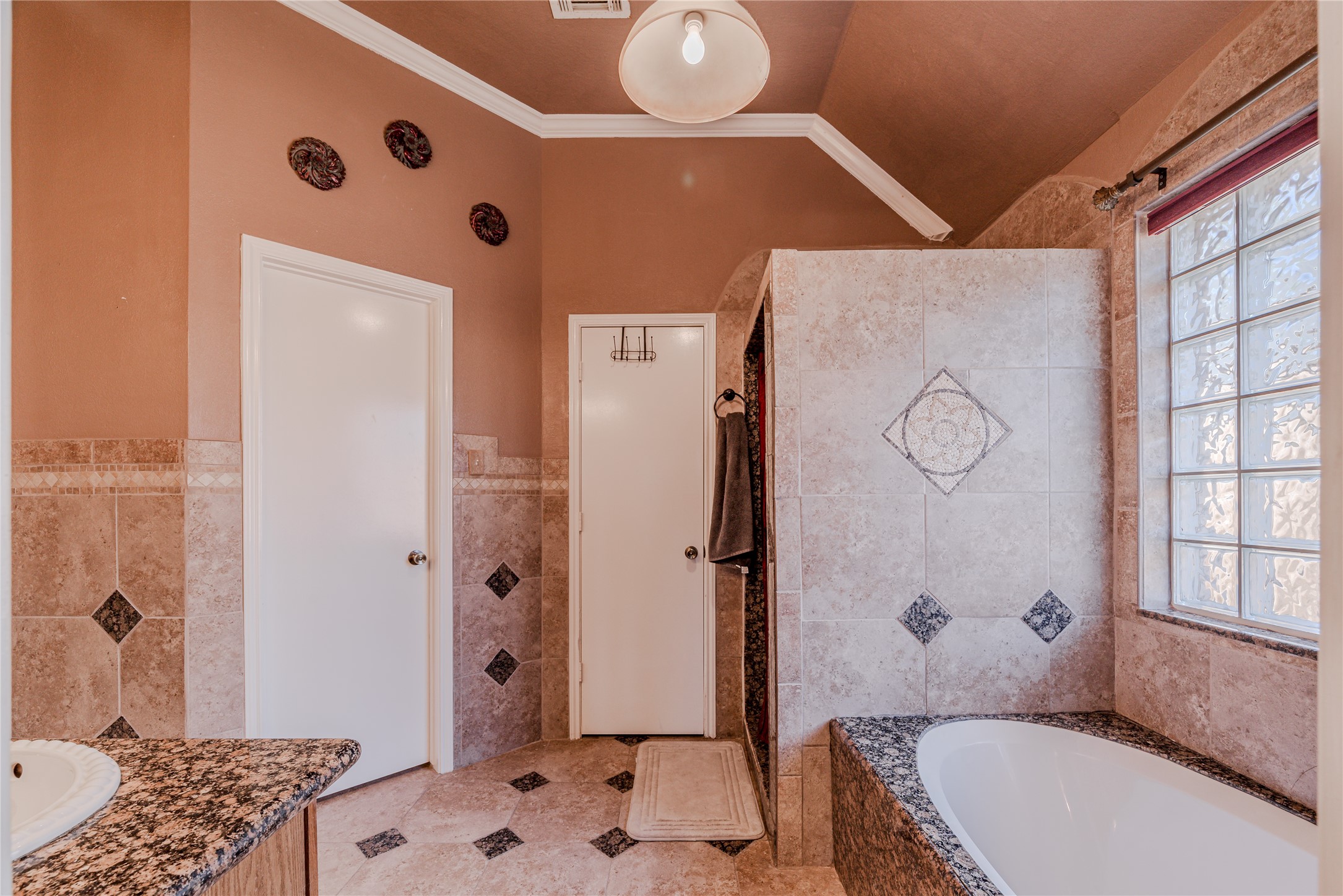7714 Broken Arrow Street Baytown, TX 77521 - Photo 22 of 41 a bathroom with a tub sink and shower