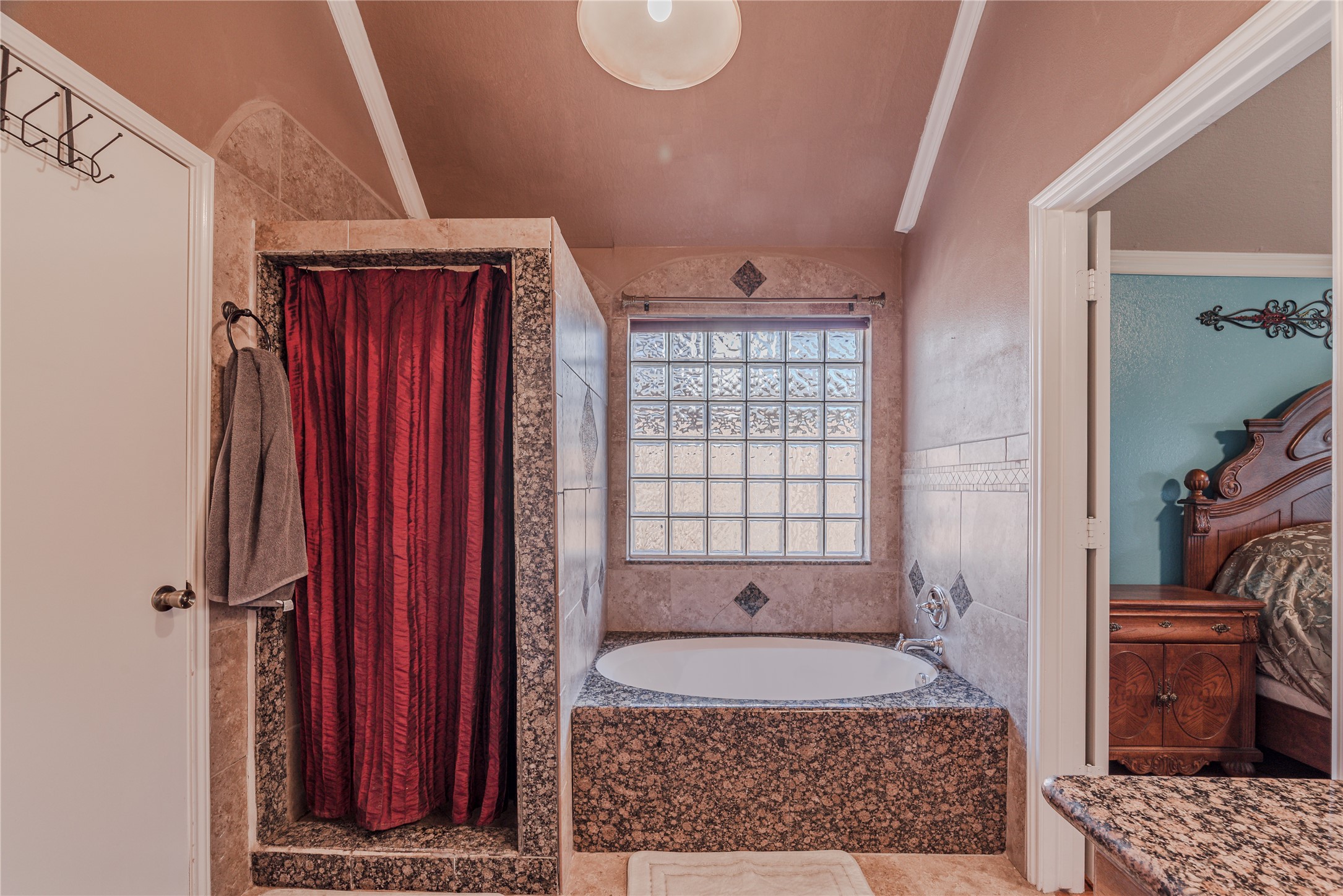 7714 Broken Arrow Street Baytown, TX 77521 - Photo 24 of 41 a bathroom with a granite countertop tub sink and mirror