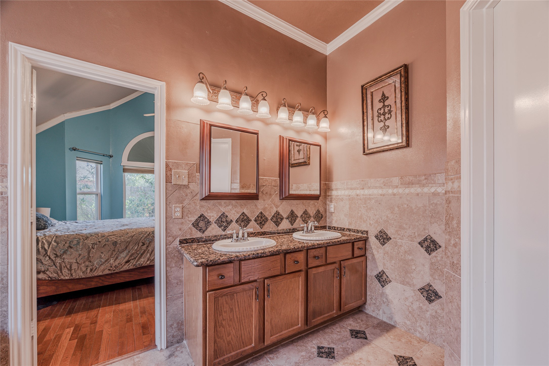 7714 Broken Arrow Street Baytown, TX 77521 - Photo 25 of 41 a en suite bathroom with a double vanity sink and a mirror
