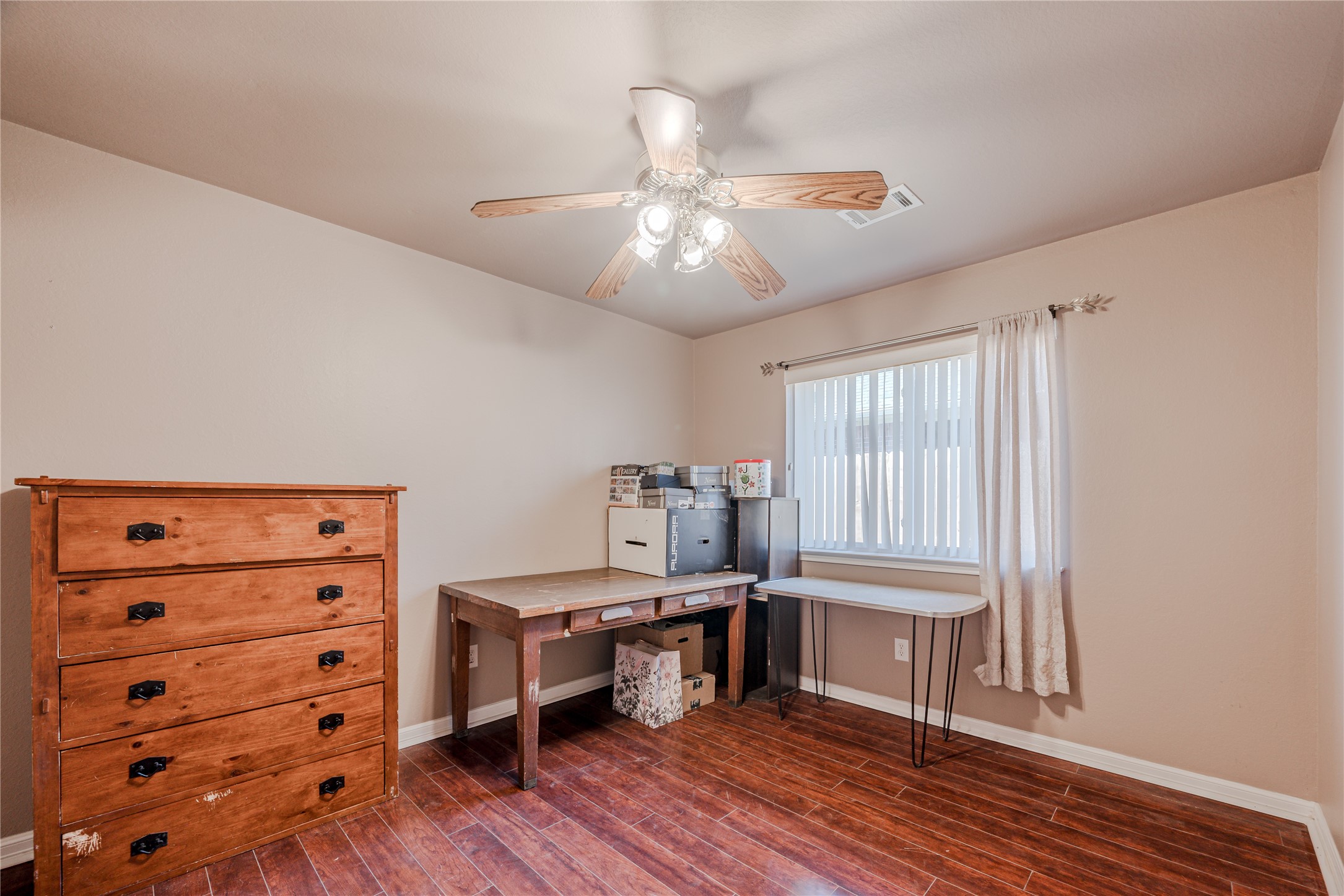 7714 Broken Arrow Street Baytown, TX 77521 - Photo 26 of 41 a bedroom with furniture and wooden floor