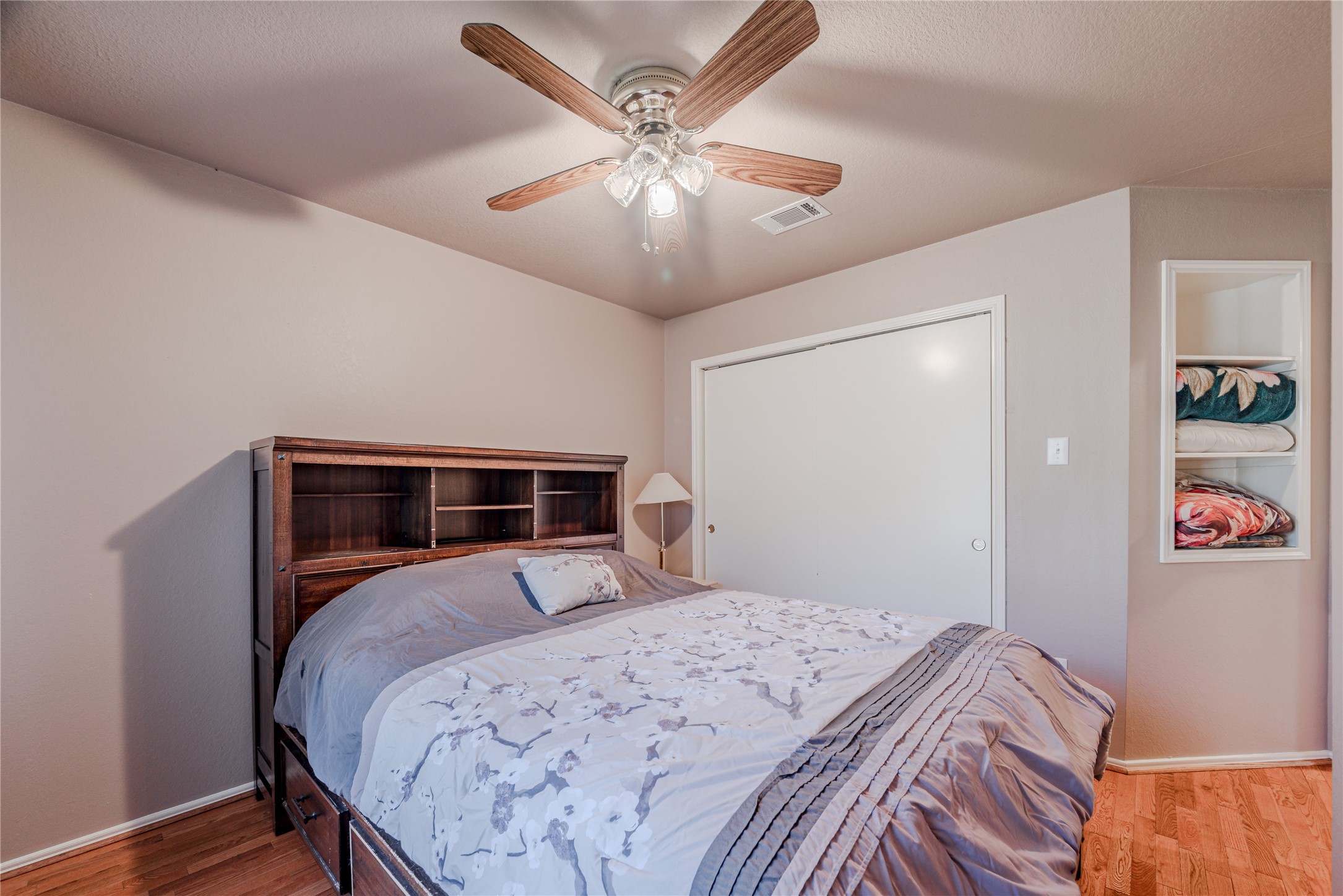 7714 Broken Arrow Street Baytown, TX 77521 - Photo 28 of 41 a bedroom with bed and a chandelier