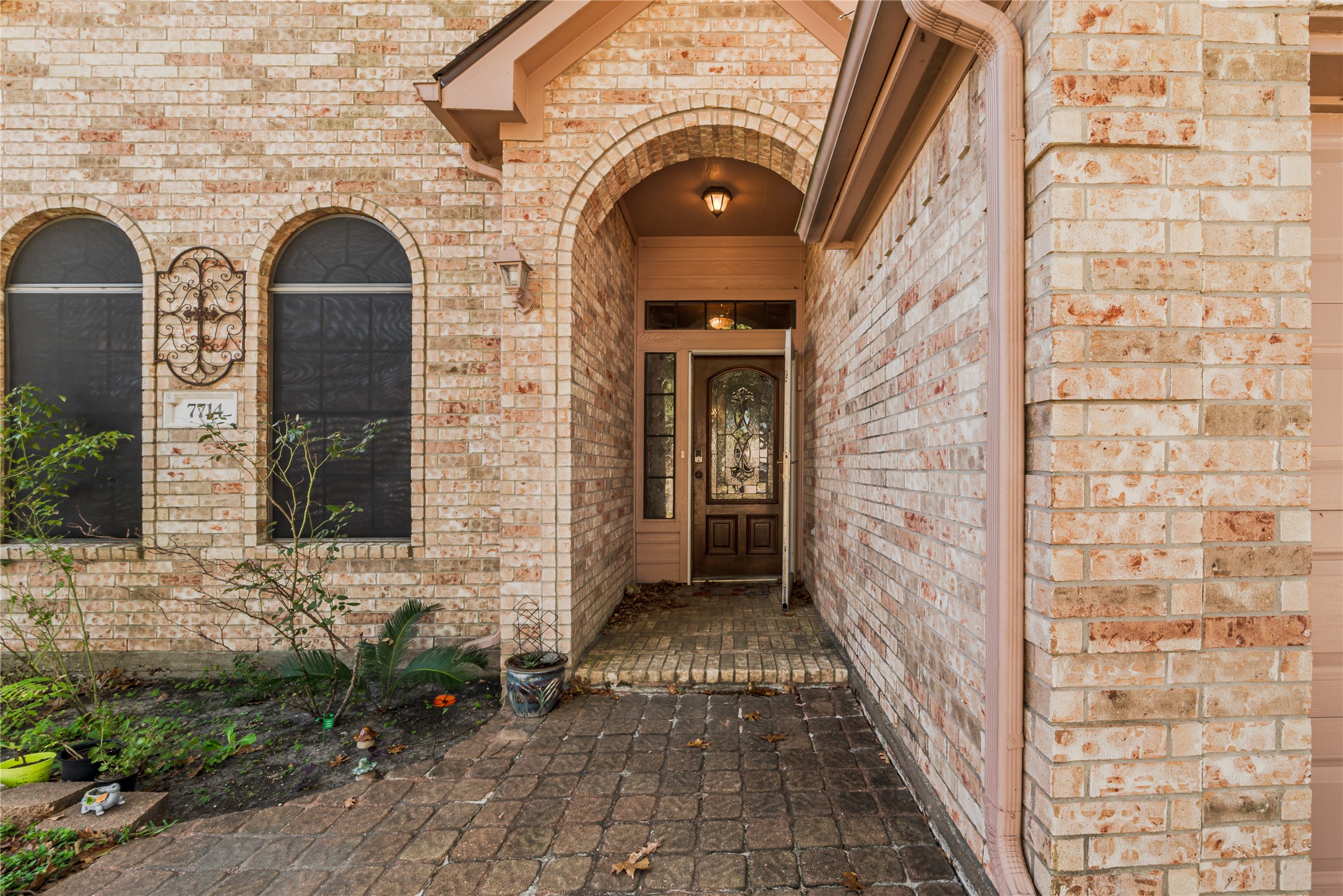 7714 Broken Arrow Street Baytown, TX 77521 - Photo 3 of 41 a view of a brick house with a door