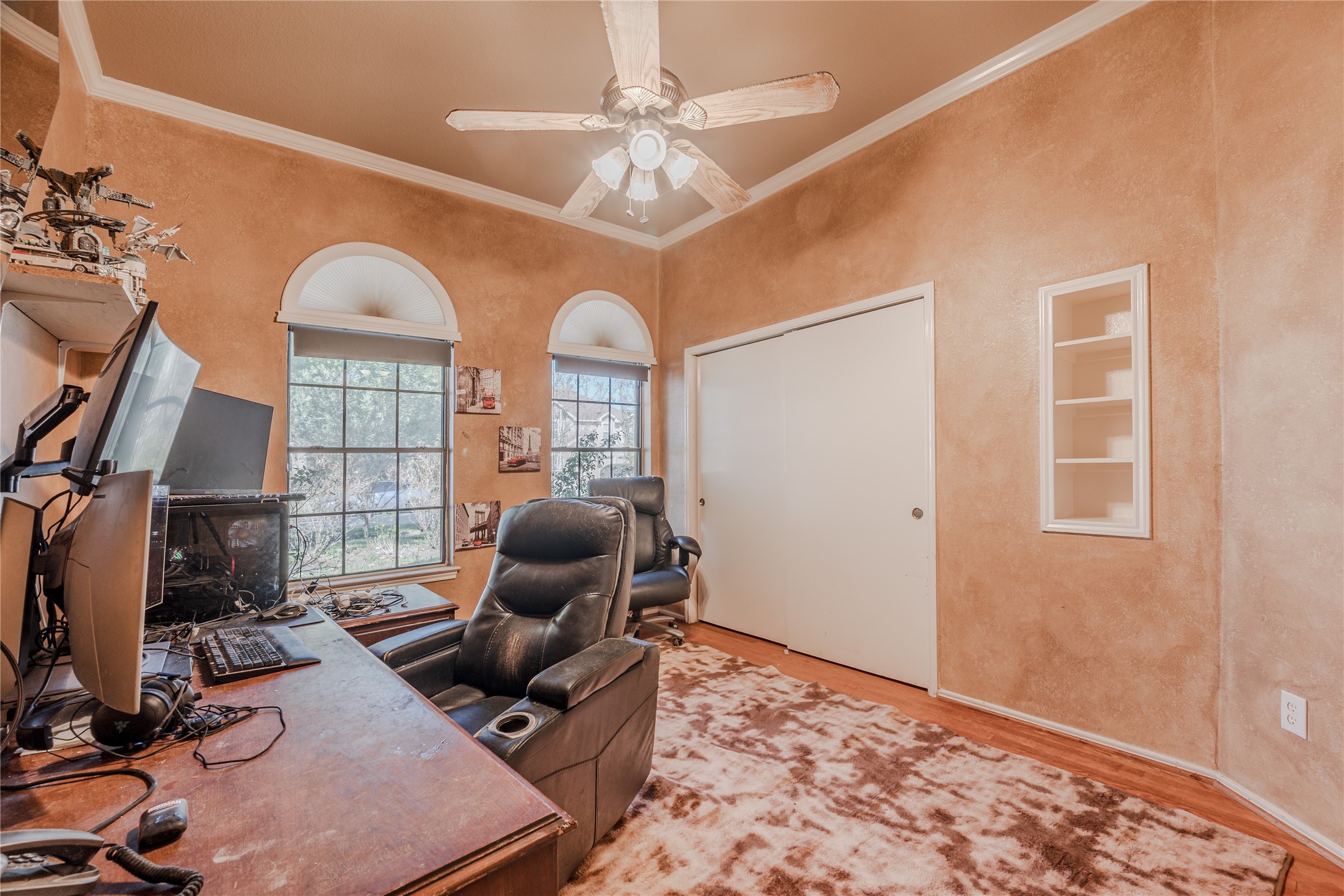 7714 Broken Arrow Street Baytown, TX 77521 - Photo 32 of 41 a workspace with chandelier fan and wooden floor