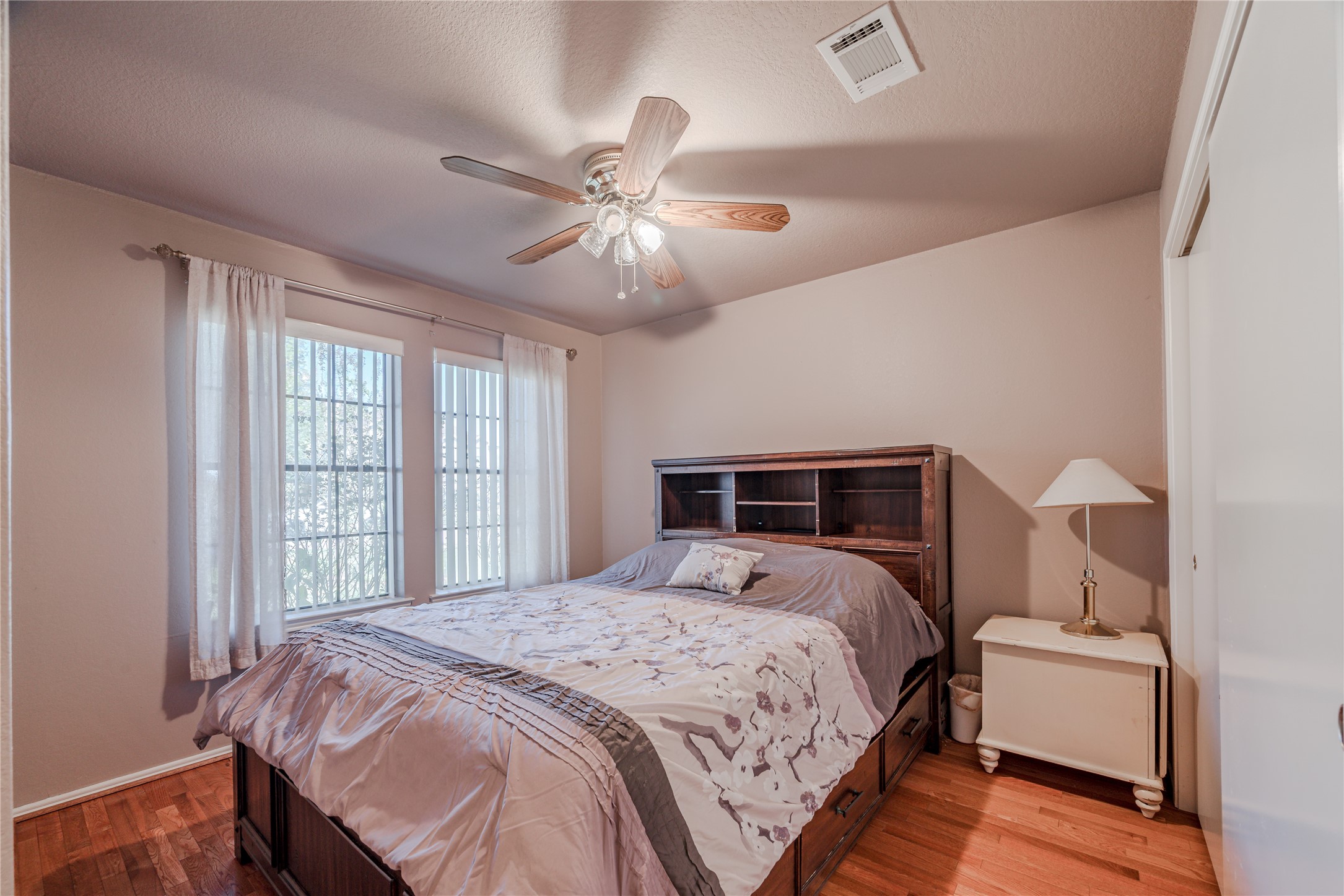 7714 Broken Arrow Street Baytown, TX 77521 - Photo 35 of 41 a bedroom with a large bed and a large window