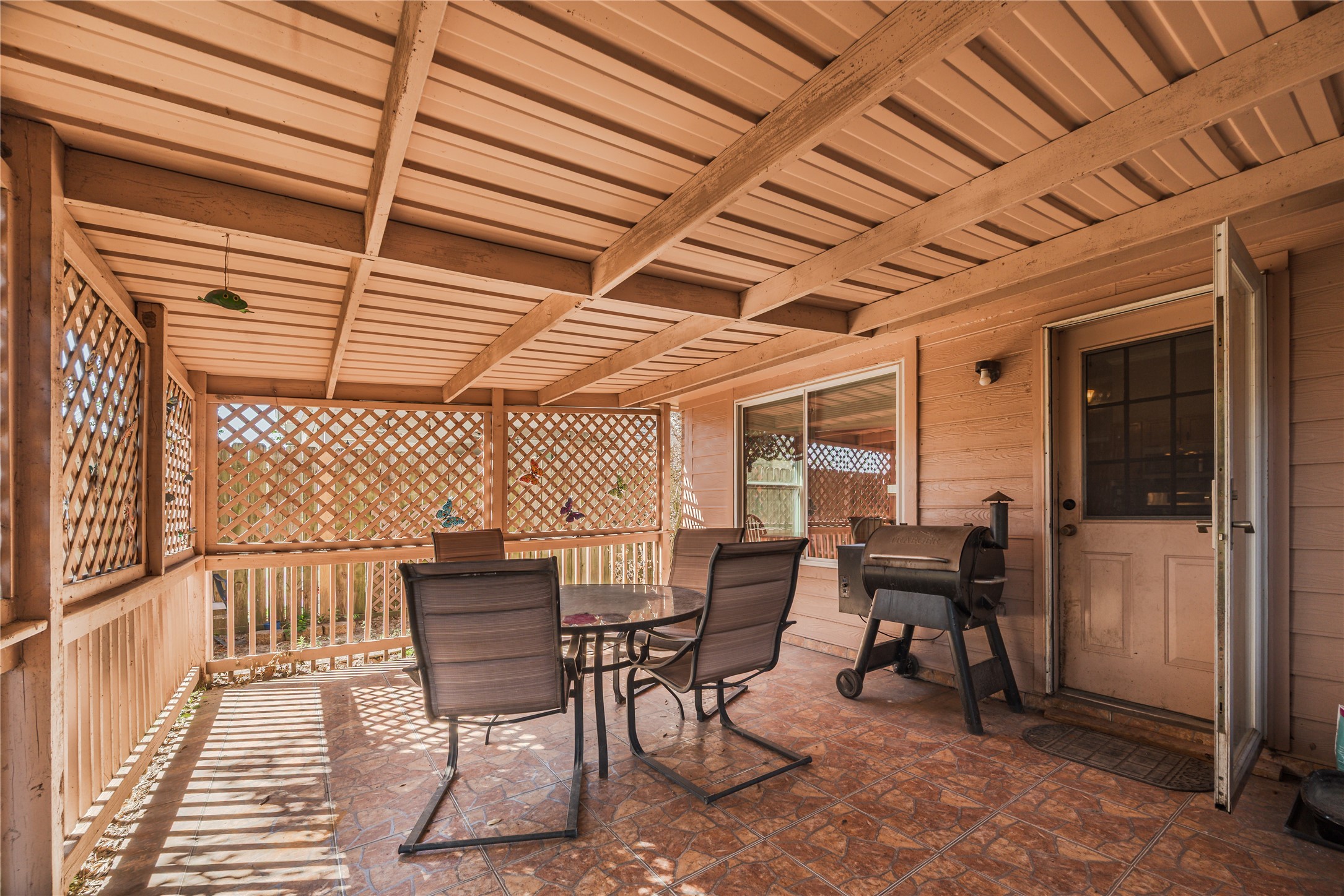 7714 Broken Arrow Street Baytown, TX 77521 - Photo 37 of 41 a patio with table and chairs
