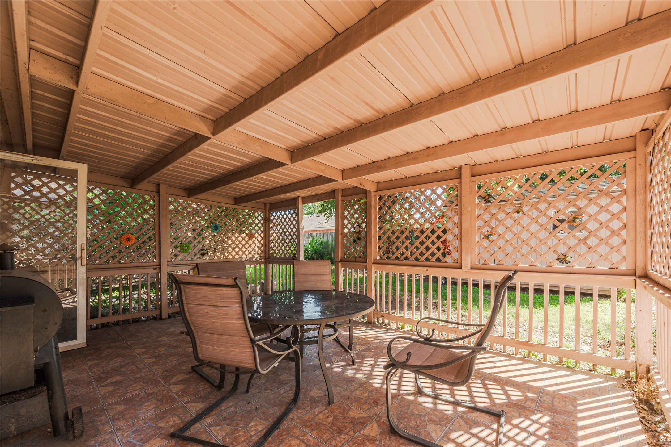 7714 Broken Arrow Street Baytown, TX 77521 - Photo 38 of 41 a view of a patio with a table and chairs