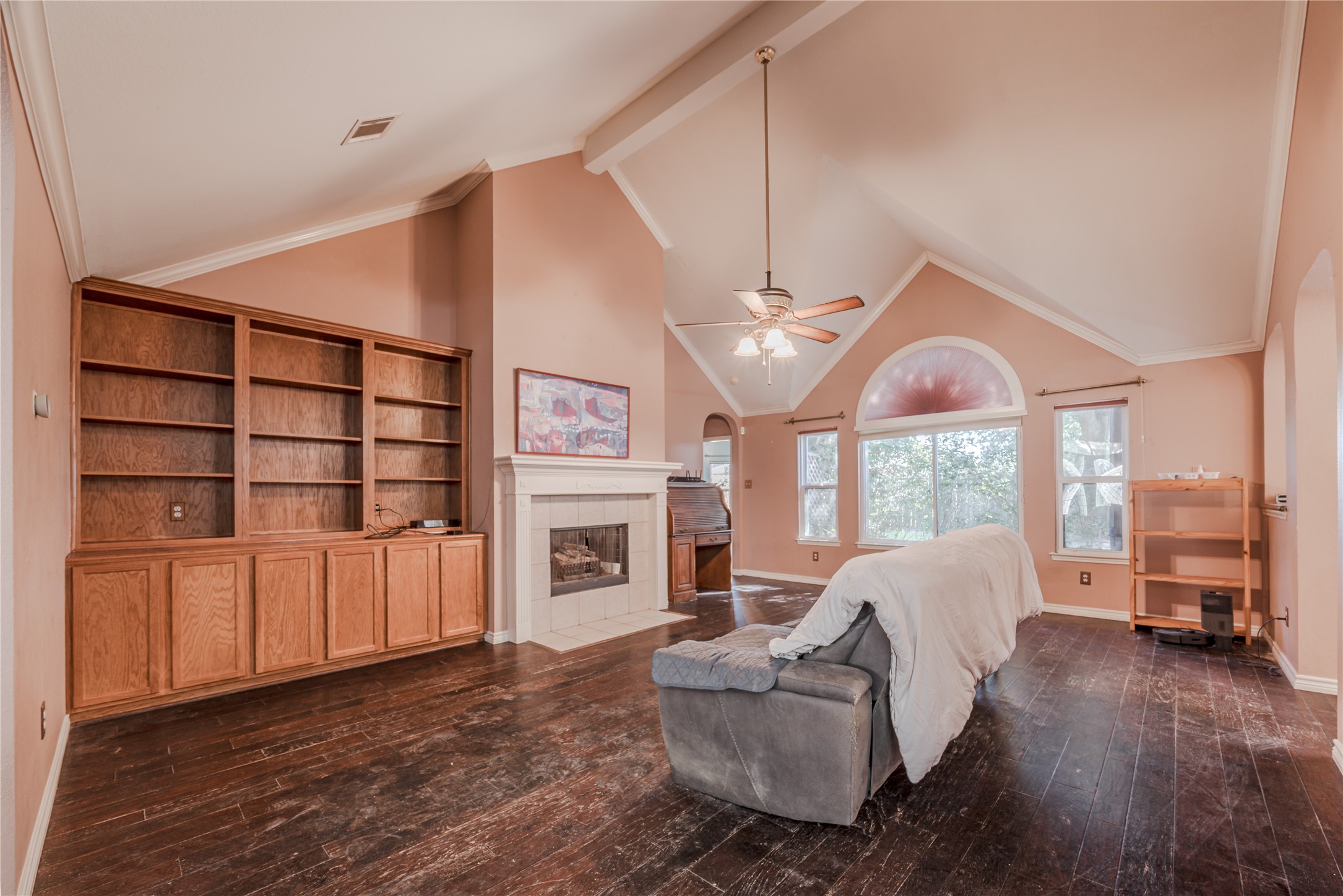 7714 Broken Arrow Street Baytown, TX 77521 - Photo 8 of 41 a living room with furniture a fireplace and a ceiling fan