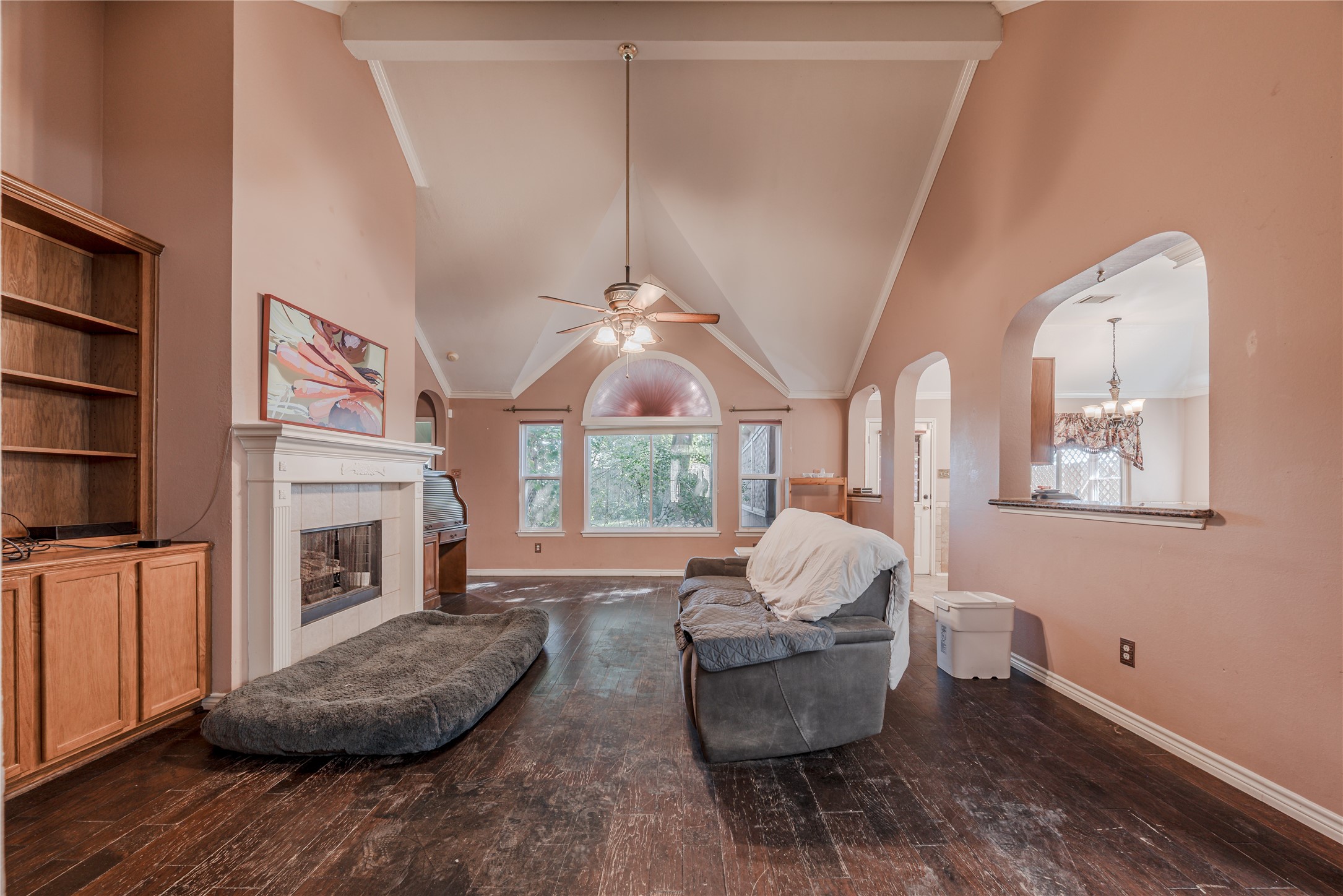 7714 Broken Arrow Street Baytown, TX 77521 - Photo 9 of 41 a living room with furniture a fireplace and a large window