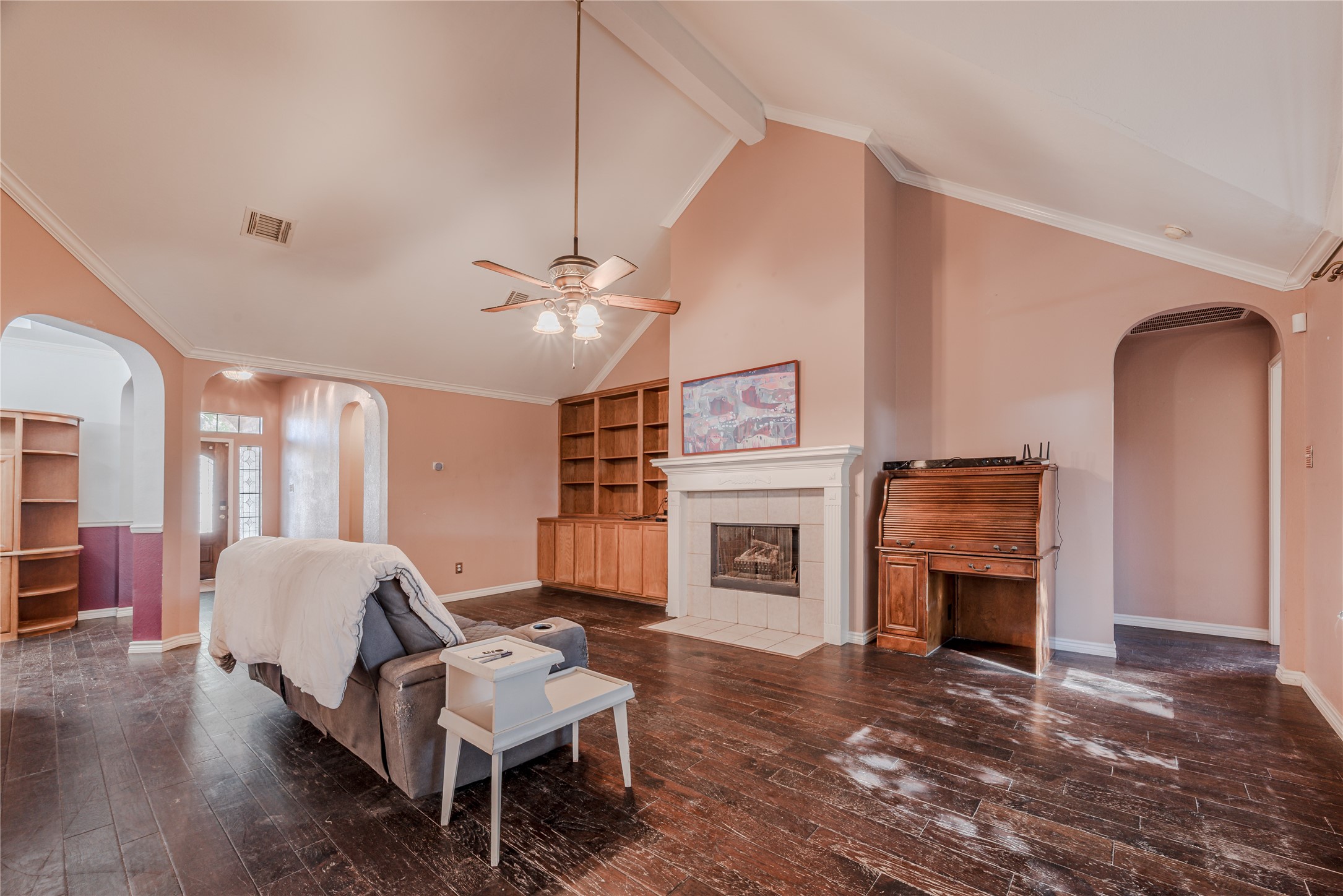7714 Broken Arrow Street Baytown, TX 77521 - Photo 10 of 41 a living room with furniture a fireplace and a flat screen tv