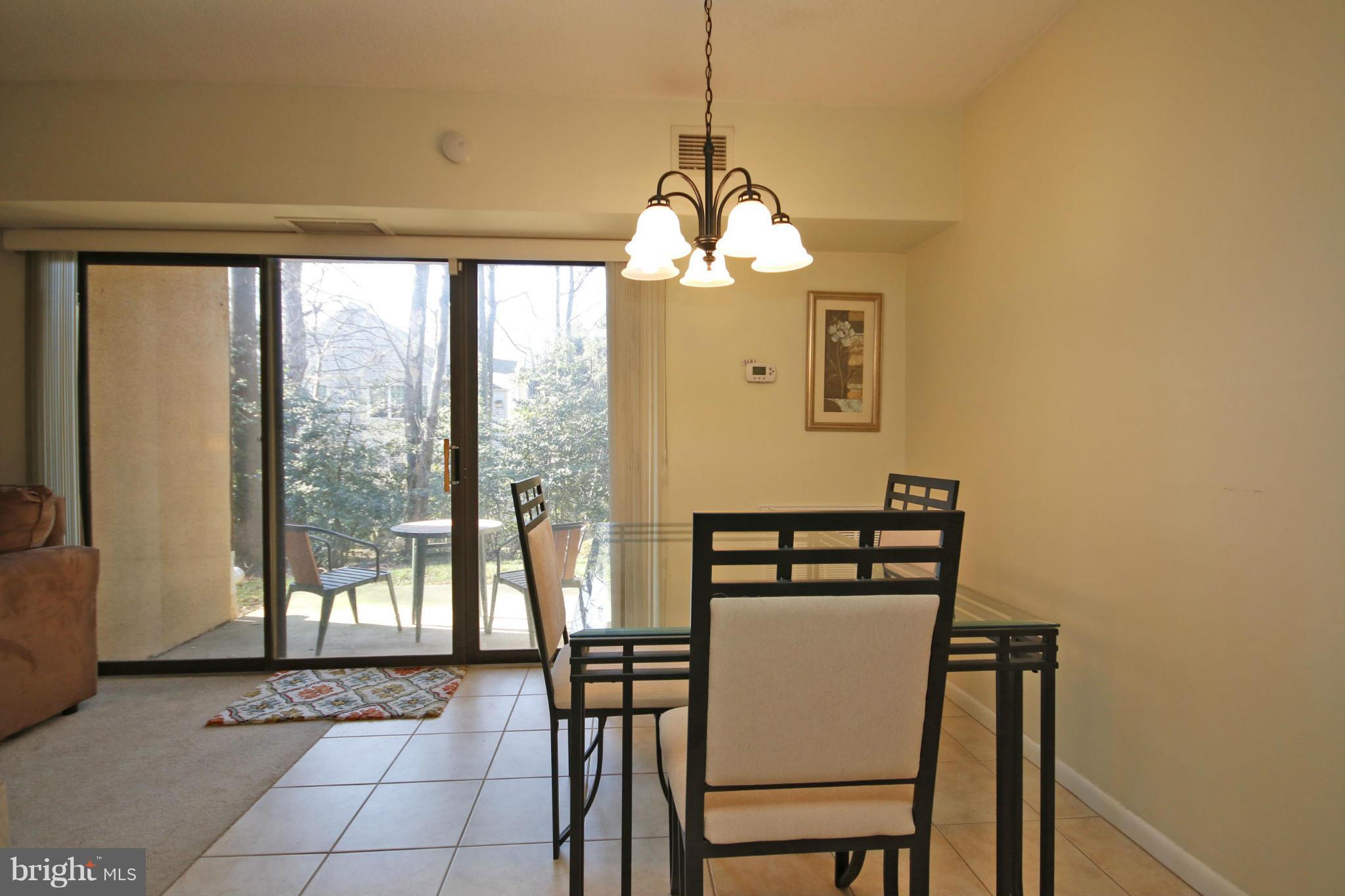 2210 Castle Rock Square, Unit 1B Reston, VA 20191 - Photo 11 of 26 a dining room with furniture and window