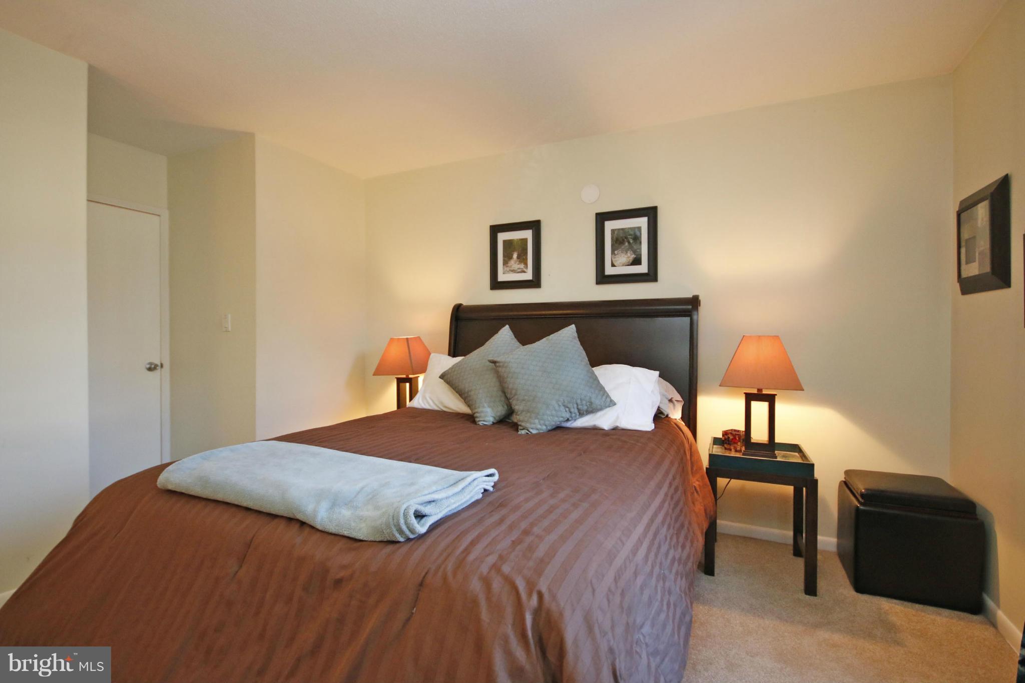 2210 Castle Rock Square, Unit 1B Reston, VA 20191 - Photo 14 of 26 a bedroom with a bed and a lamp