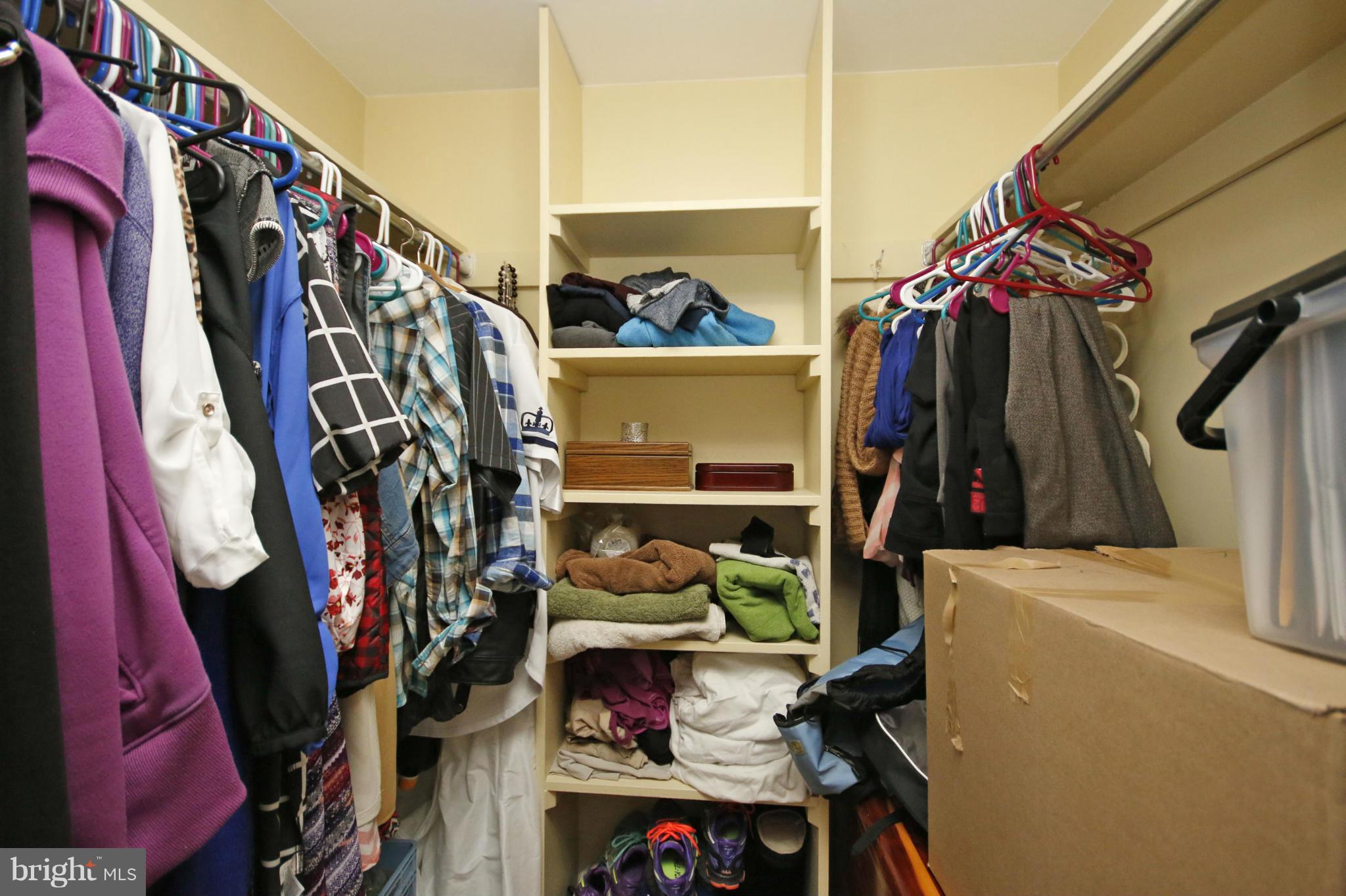 2210 Castle Rock Square, Unit 1B Reston, VA 20191 - Photo 17 of 26 a view of walk in closet with clothes and shoes