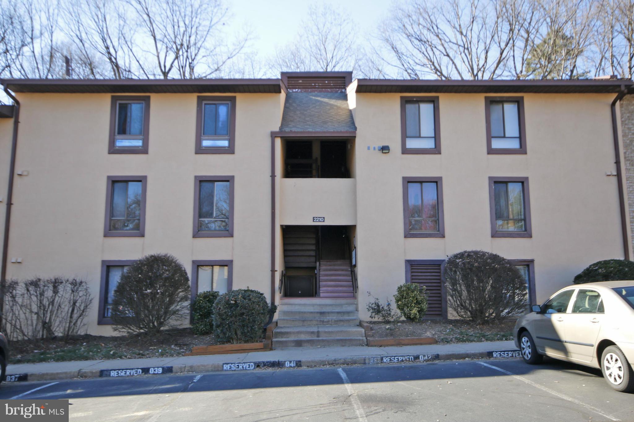 2210 Castle Rock Square, Unit 1B Reston, VA 20191 - Photo 3 of 26 a front view of a house with garage