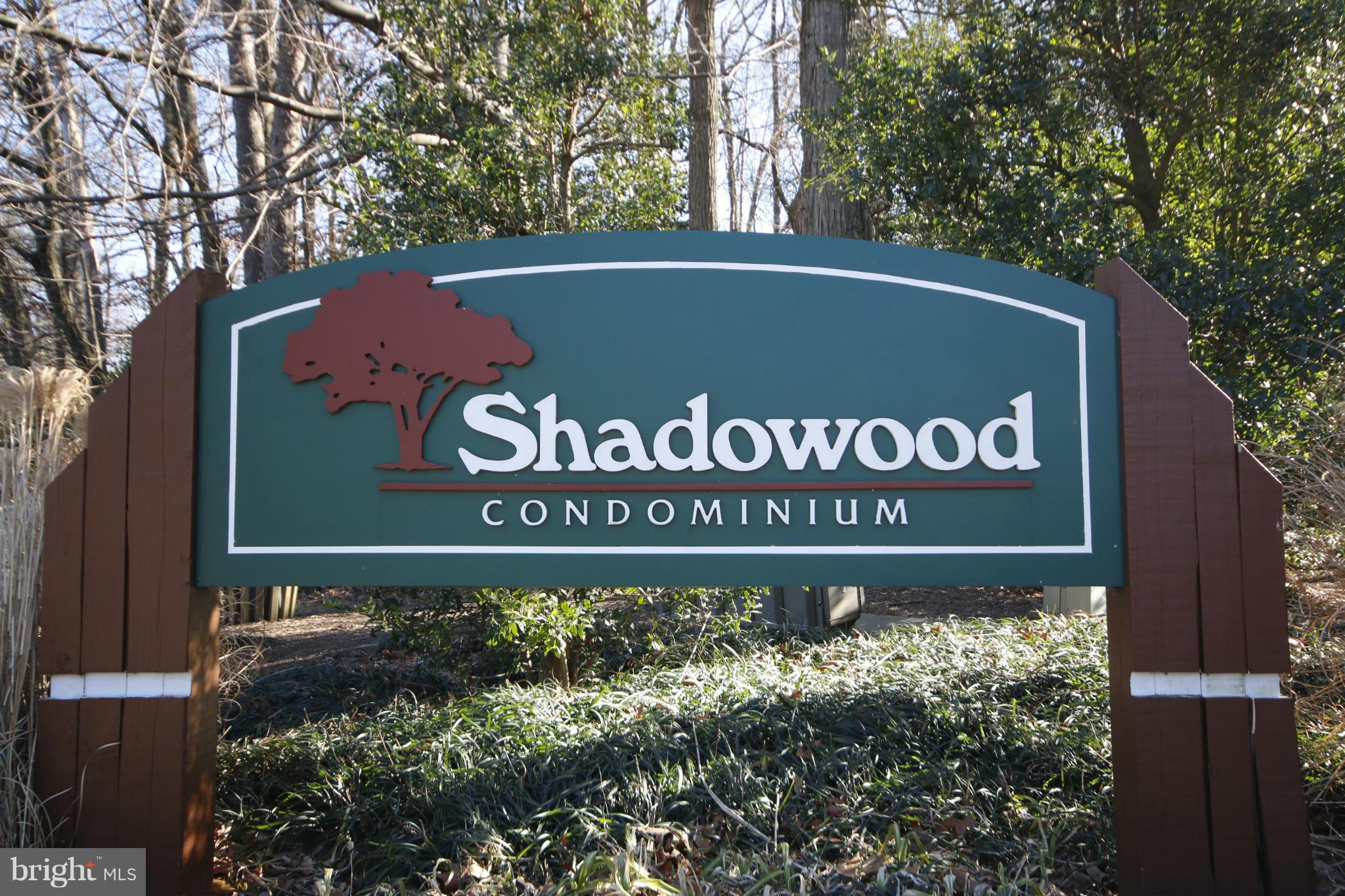2210 Castle Rock Square, Unit 1B Reston, VA 20191 - Photo 25 of 26 a sign broad in front of flowers